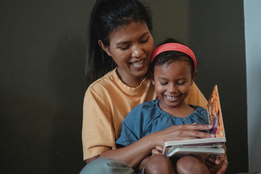 A mother and daughter reading a book together